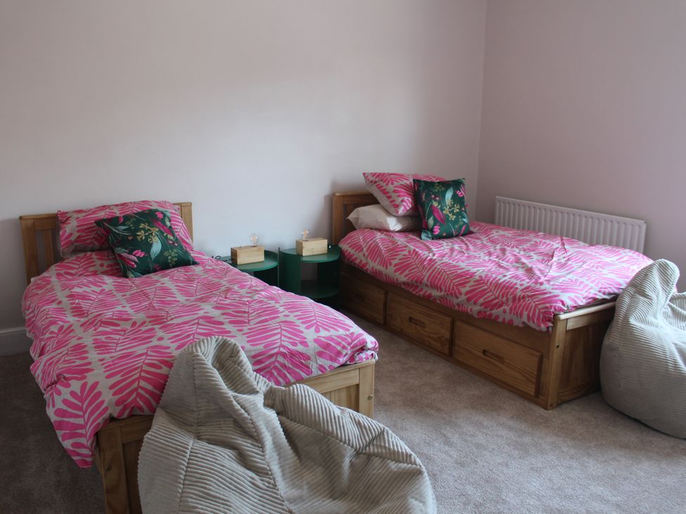 A bedroom with two beds and bean bags at Felix Cottage in Canterbury