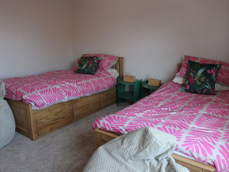 A bedroom with two single beds and nightstands at Felix Cottage in Canterbury