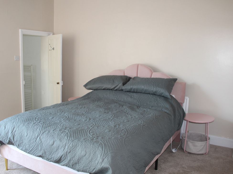 A bedroom with a bed and bedside table at Felix Cottage in Canterbury