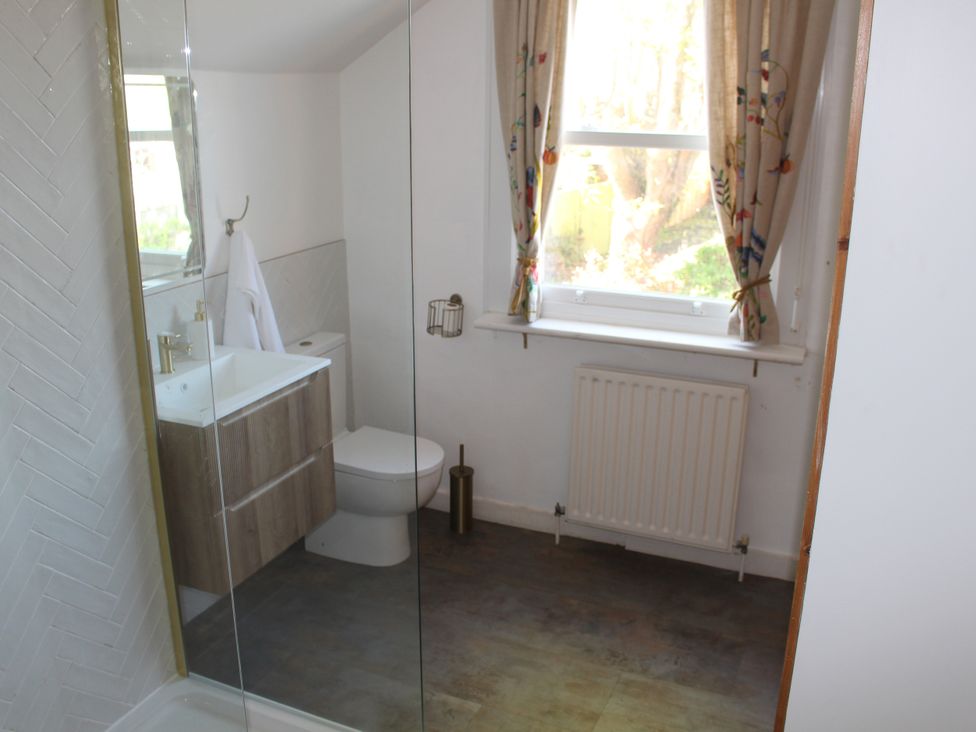 A bathroom with a shower, sink, and toilet at Felix Cottage in Canterbury