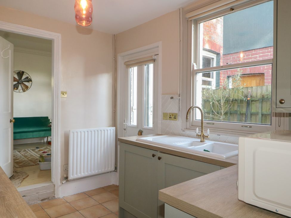 A kitchen with a sink and microwave at Felix Cottage in Canterbury