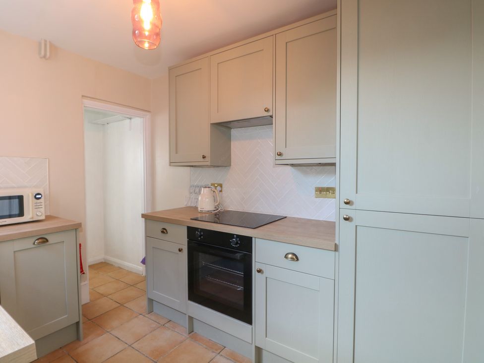 A kitchen with cabinets and appliances at Felix Cottage in Canterbury