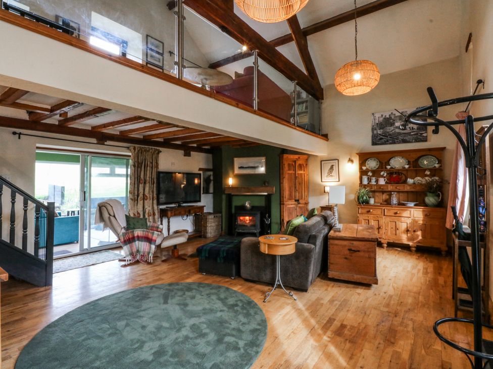 A living room with a sofa and coffee table at Pen Glorian, Conwy