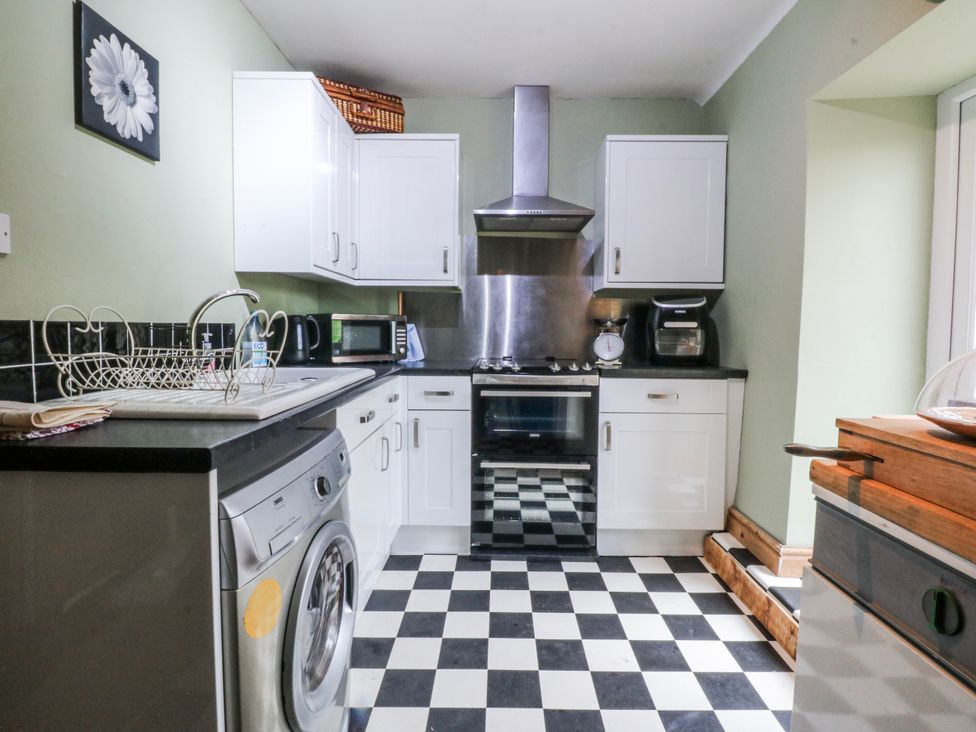 A kitchen with appliances and cabinets at Pen Glorian in Conwy
