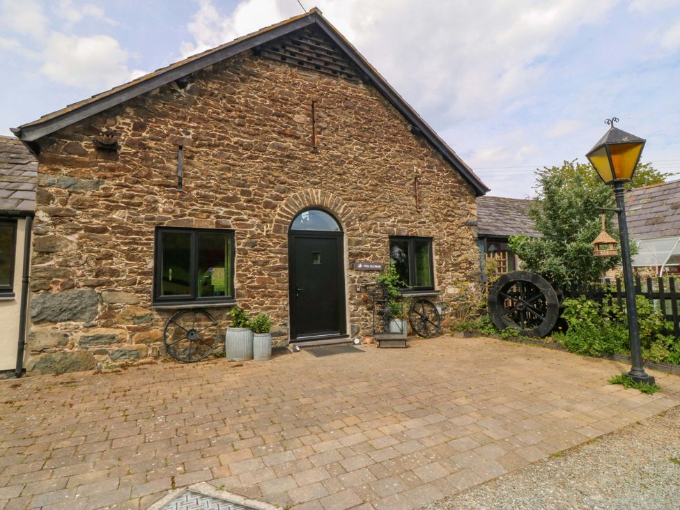 An outdoor view of a stone building entrance at Pen Glorian in Conwy