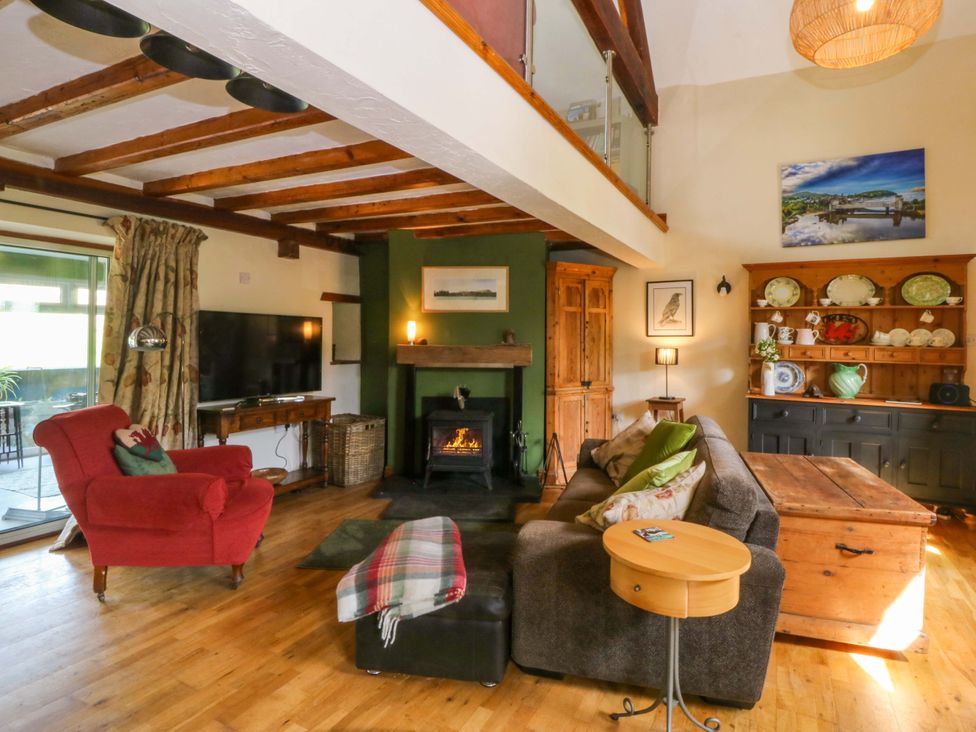 A living room with a fireplace and sofa at Pen Glorian in Conwy