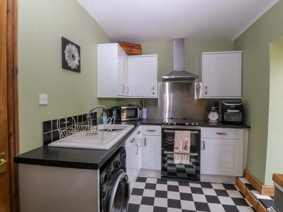 A kitchen with appliances and cabinets at Pen Glorian in Conwy