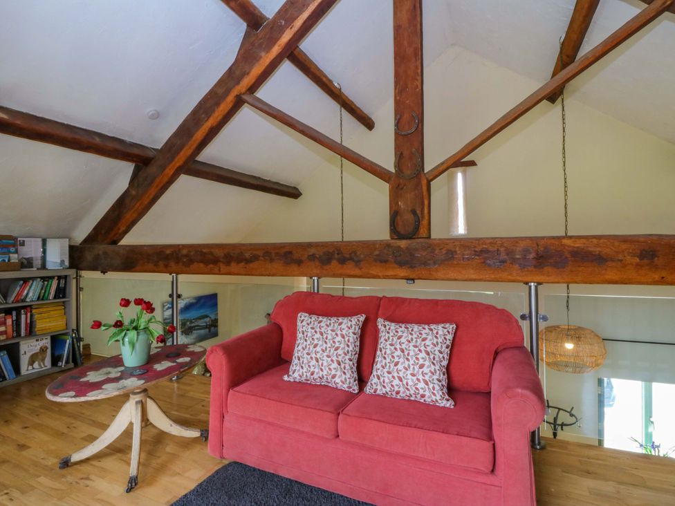A snug area with a sofa and table at Pen Glorian in Conwy