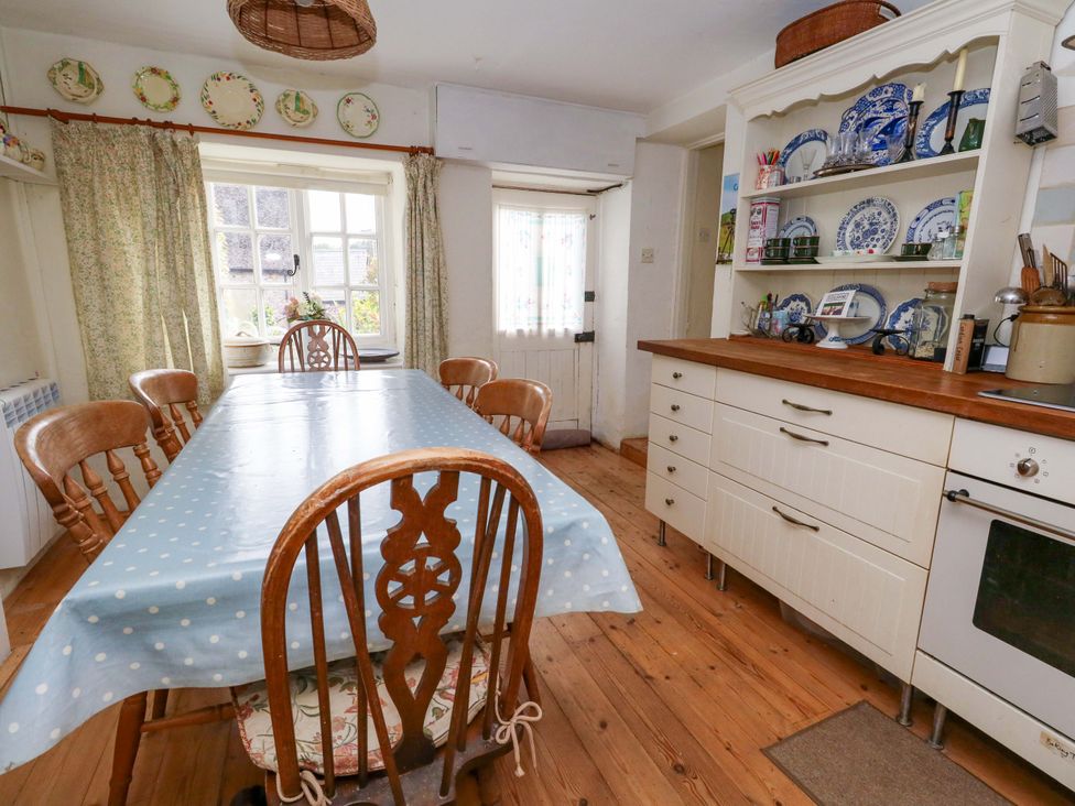 A kitchen with a dining table and chairs at Little Orchard in Chard