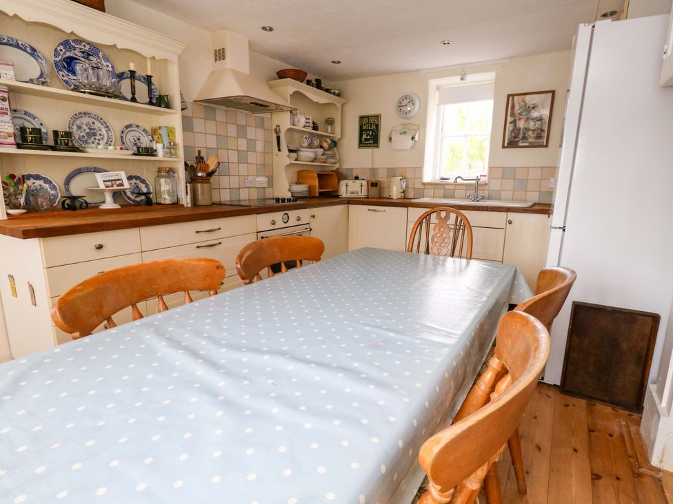 A kitchen with a table and chairs at Little Orchard in Chard
