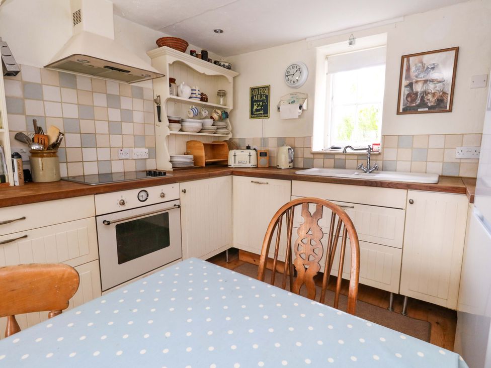 A kitchen with a table and chairs at Little Orchard in Chard
