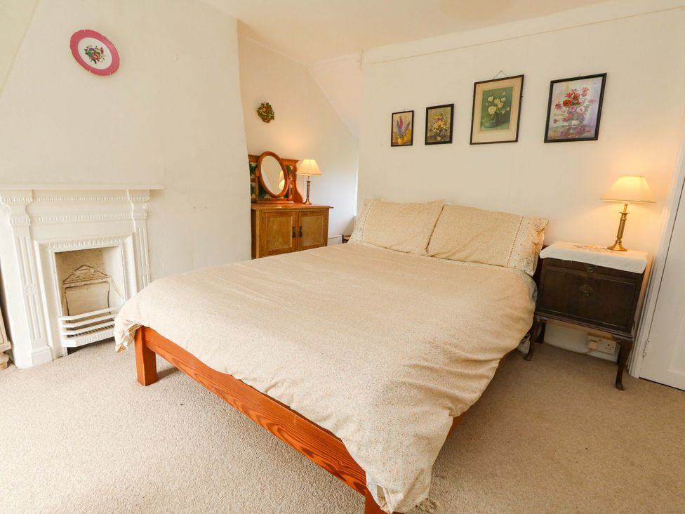 A bedroom with a bed and a bedside table at Little Orchard in Chard