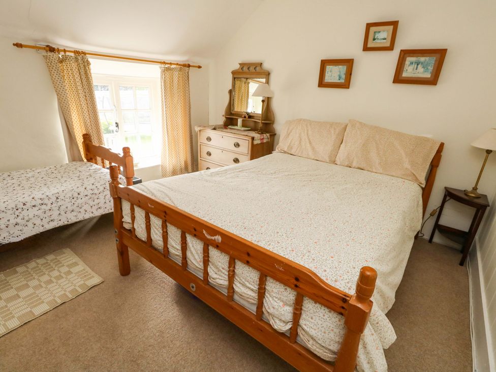 A bedroom with a double bed and a dresser at Little Orchard in Chard