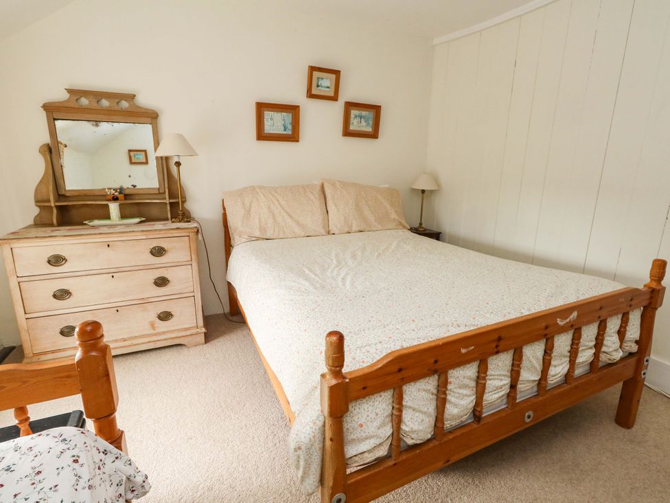 A bedroom with a bed and dresser at Little Orchard in Chard