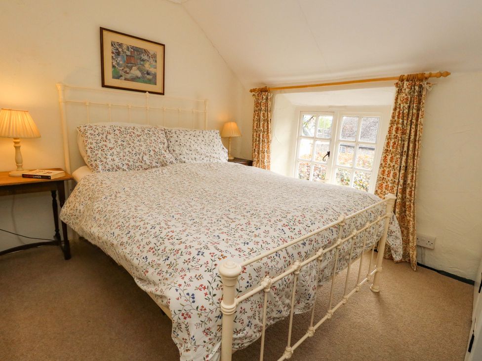 A bedroom with a bed and bedside table at Little Orchard in Chard