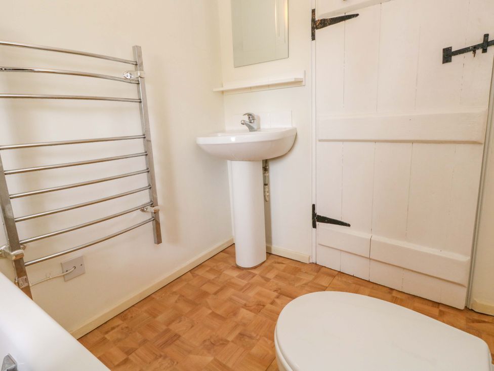 A bathroom with a toilet and sink at Little Orchard in Chard