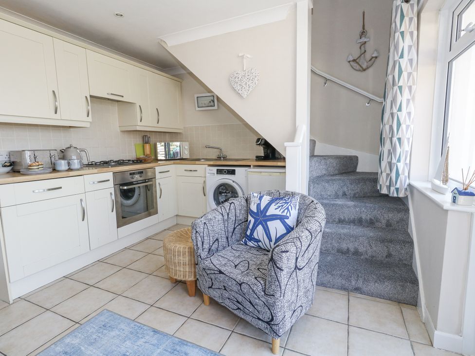 A kitchen with counter and appliances at Sea Spray in Bowleaze