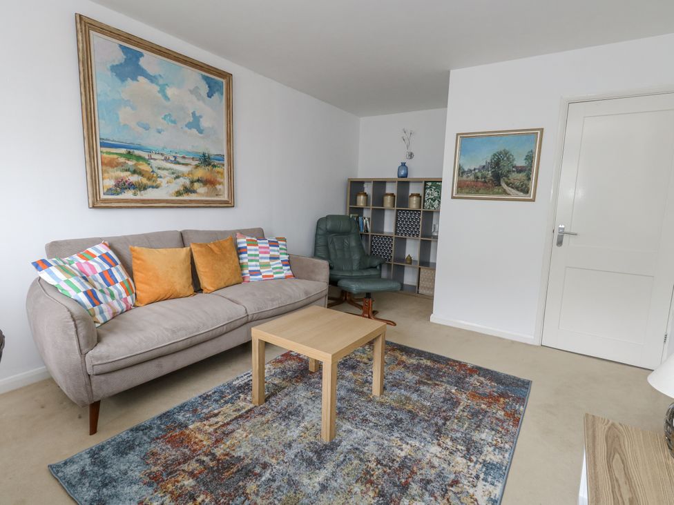 A living room with a sofa and coffee table at Flat 13, Chesil House in Bridport