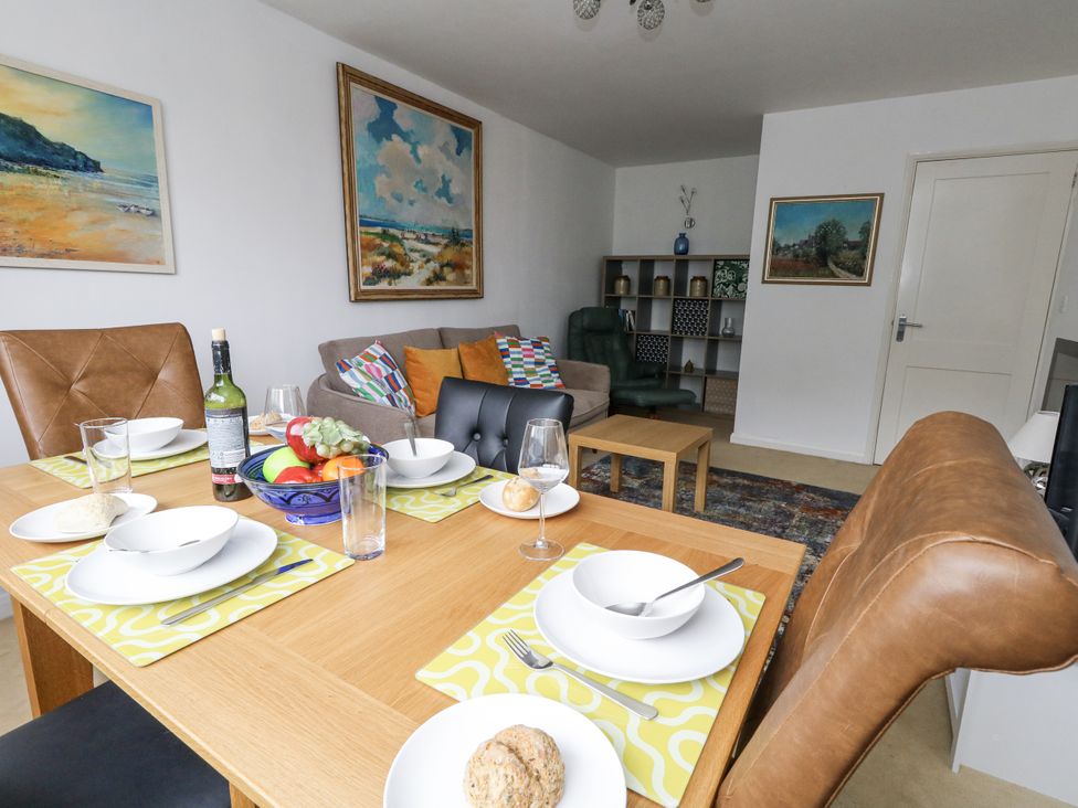 A dining area with a table set and furniture at Flat 13, Chesil House in Bridport