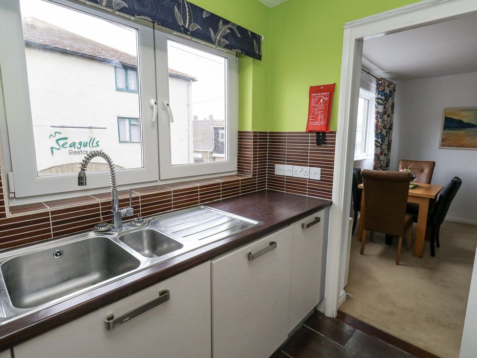 A kitchen with a sink and countertops at Flat 13, Chesil House in Bridport