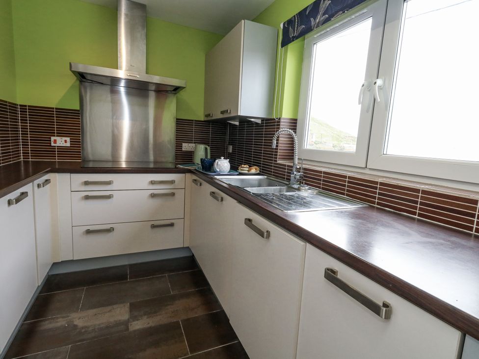 A kitchen with cabinets, sink, and countertop at Flat 13, Chesil House in Bridport