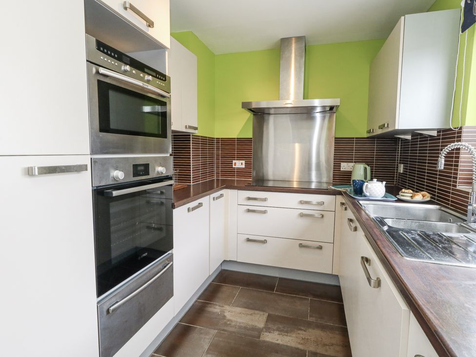 A kitchen with appliances and a sink at Flat 13, Chesil House Bridport