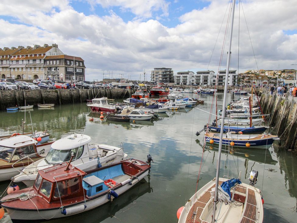 A harbor with boats and buildings at Flat 13, Chesil House in Bridport