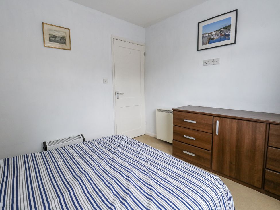 A bedroom with a bed and chest of drawers at Beachcombers, 13 Chesil House Bridport