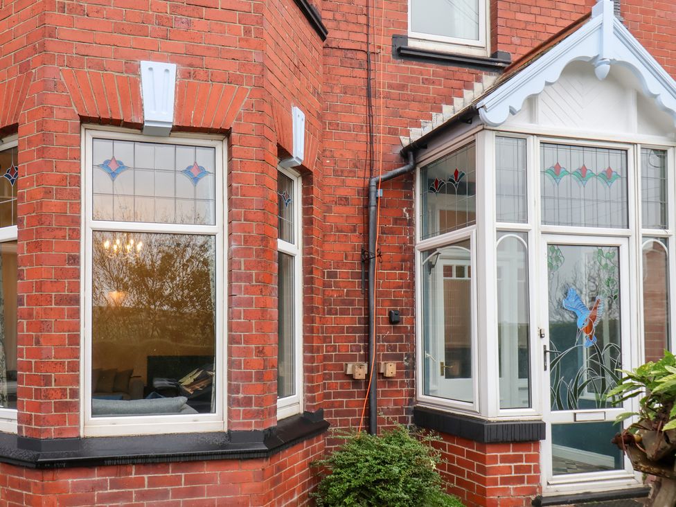 Exterior view of a house with stained glass windows at Kingfisher House in Saltburn-by-the-Sea