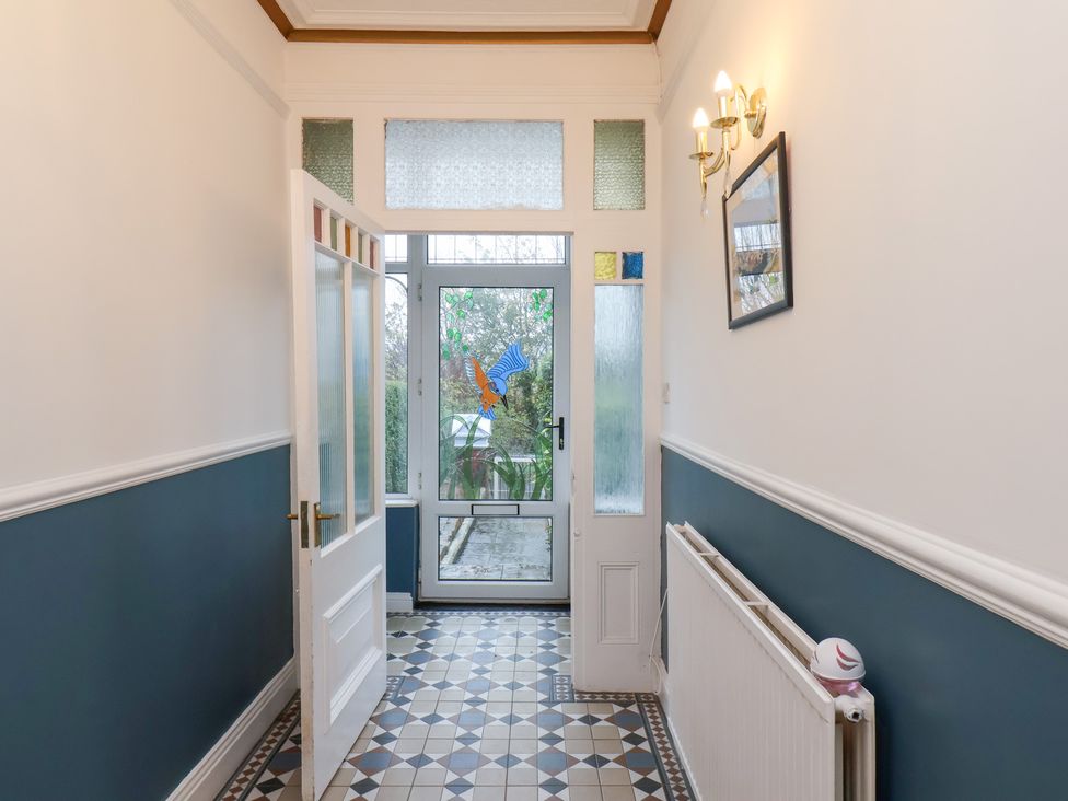 A hallway with a door and window at Kingfisher House Saltburn-by-the-Sea