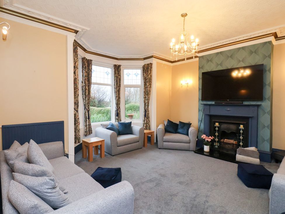 A living room with a sofa and television at Kingfisher House Saltburn-by-the-Sea