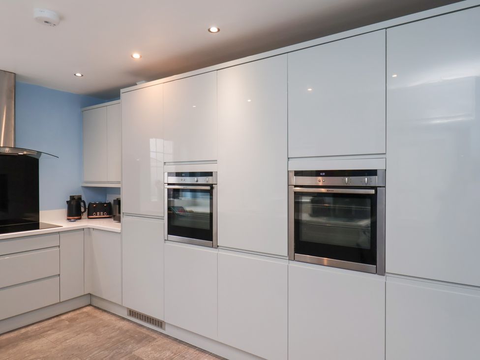 A kitchen with built-in ovens and a stovetop at Kingfisher House in Saltburn-by-the-Sea
