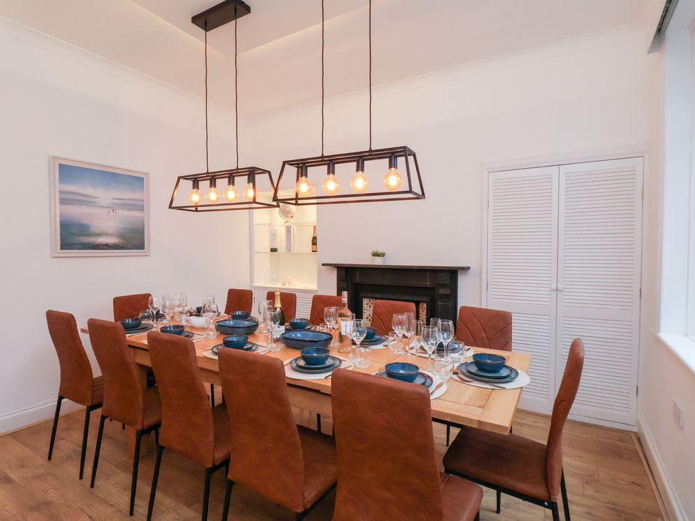A dining room with a large table and chairs at Kingfisher House Saltburn-by-the-Sea