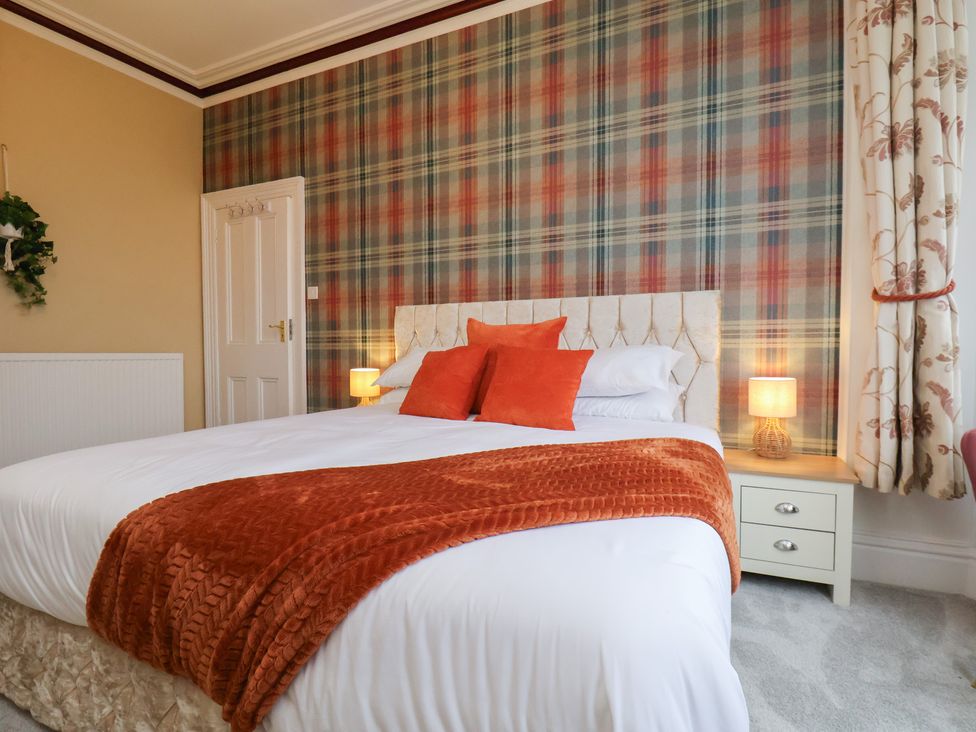 A bedroom with a bed and nightstand at Kingfisher House in Saltburn-by-the-Sea