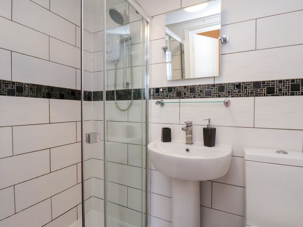 A bathroom with a shower, sink, and toilet at Kingfisher House in Saltburn-by-the-Sea