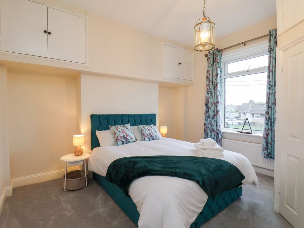 A bedroom with a bed and bedside table at Kingfisher House in Saltburn-by-the-Sea
