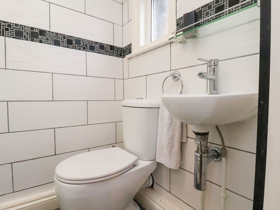 A bathroom with a toilet and sink at Kingfisher House in Saltburn-by-the-Sea