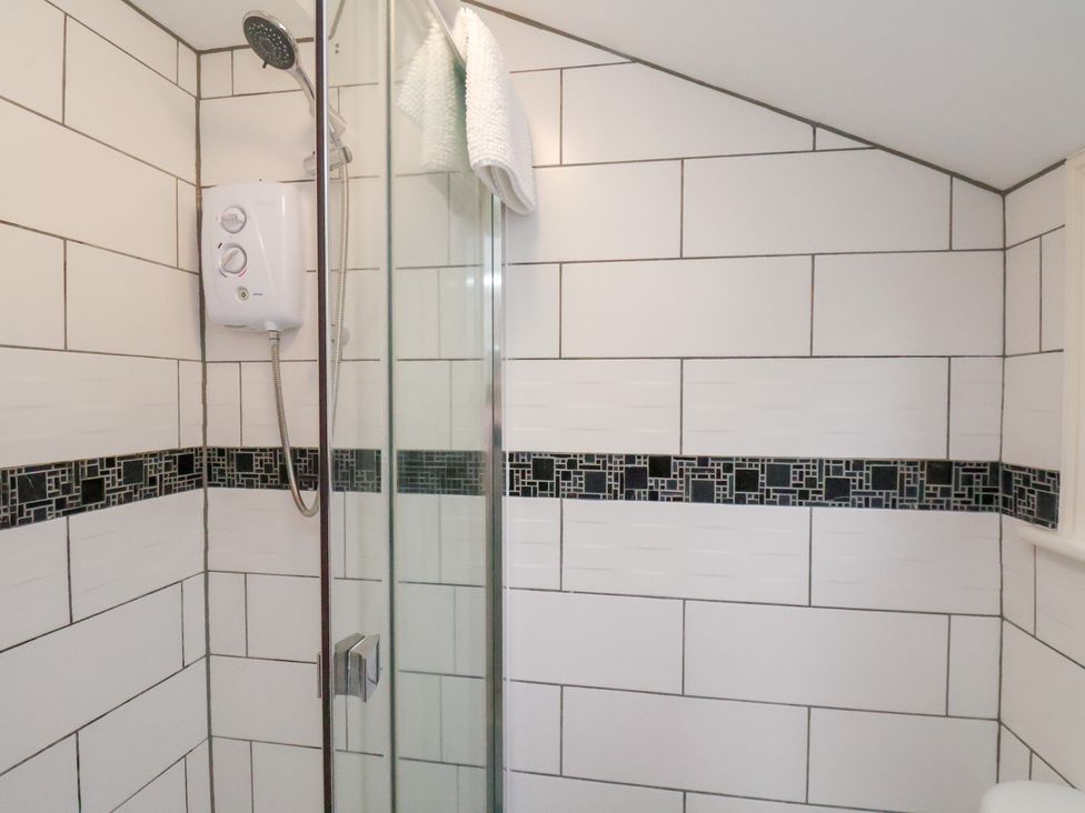 A bathroom with a shower and water heater at Kingfisher House in Saltburn-by-the-Sea