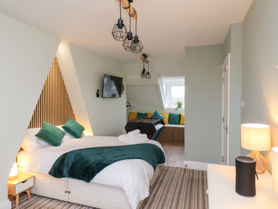 A bedroom with a bed and television at Kingfisher House in Saltburn-by-the-Sea