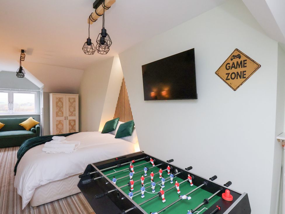 A bedroom with a foosball table and television at Kingfisher House in Saltburn-by-the-Sea