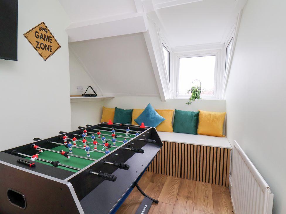 A game room with a foosball table and cushions at Kingfisher House in Saltburn-by-the-Sea