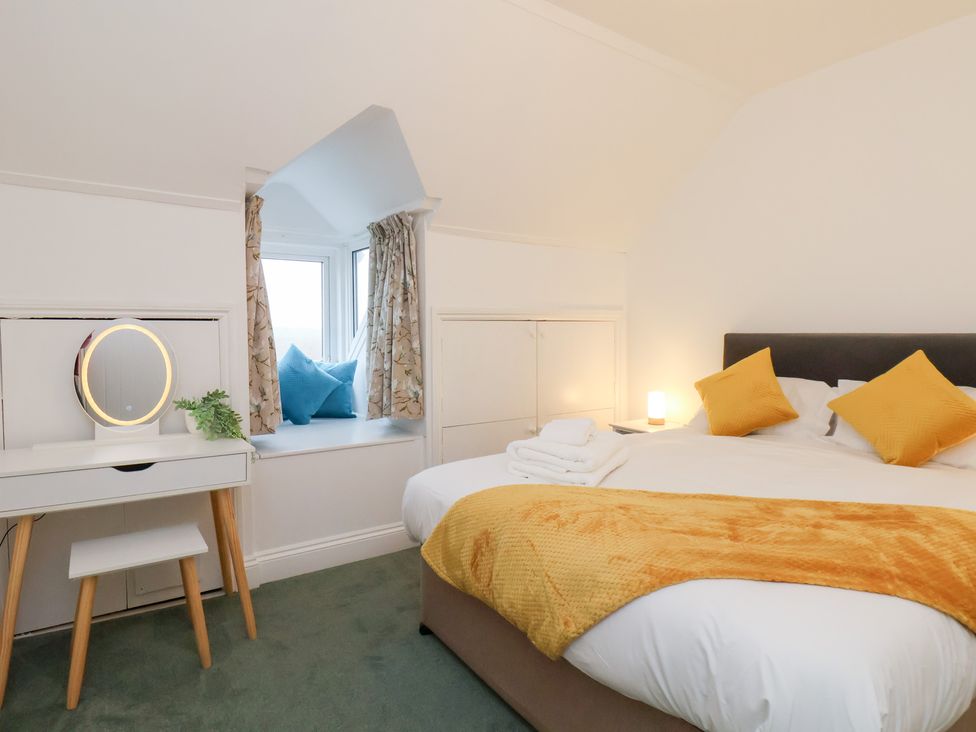 A bedroom with a bed and a dresser at Kingfisher House in Saltburn-by-the-Sea