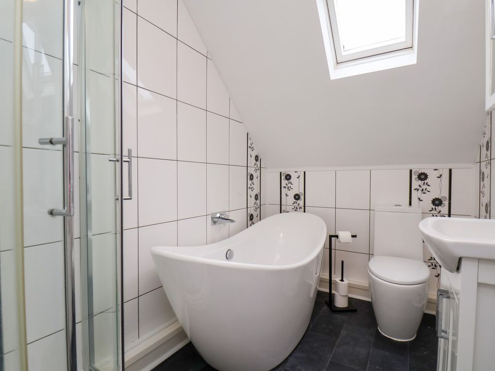 A bathroom with a bathtub, shower and toilet at Kingfisher House in Saltburn-by-the-Sea