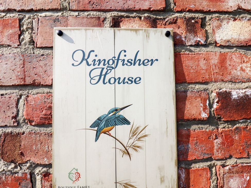 A sign displaying 'Kingfisher House' on a brick wall at Kingfisher House in Staithes