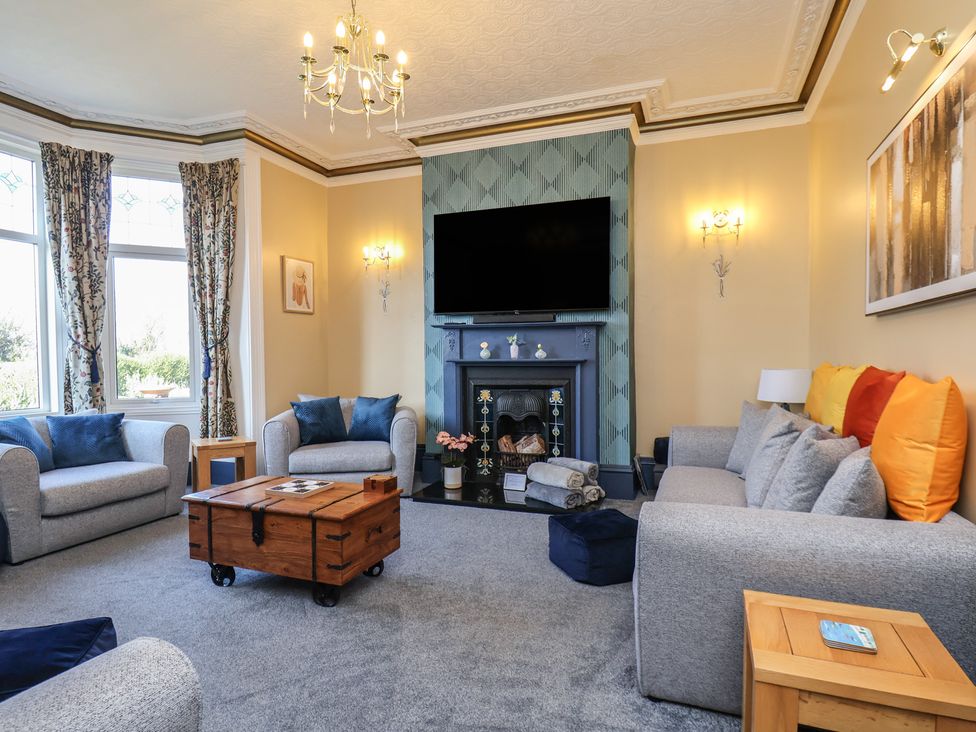 A living room with a fireplace and television at Kingfisher House in Staithes
