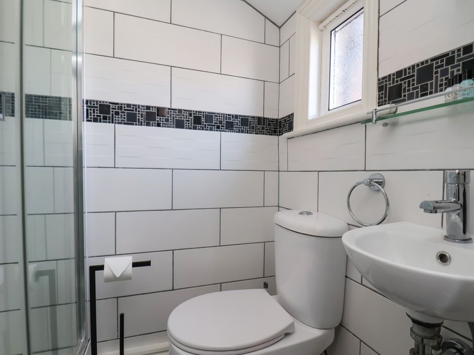 A bathroom with a toilet and sink at Kingfisher House Staithes