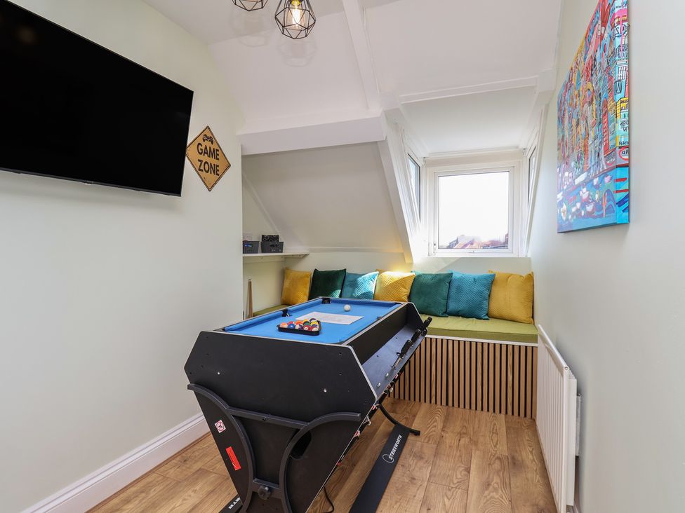 A game room with a pool table and cushions at Kingfisher House Staithes