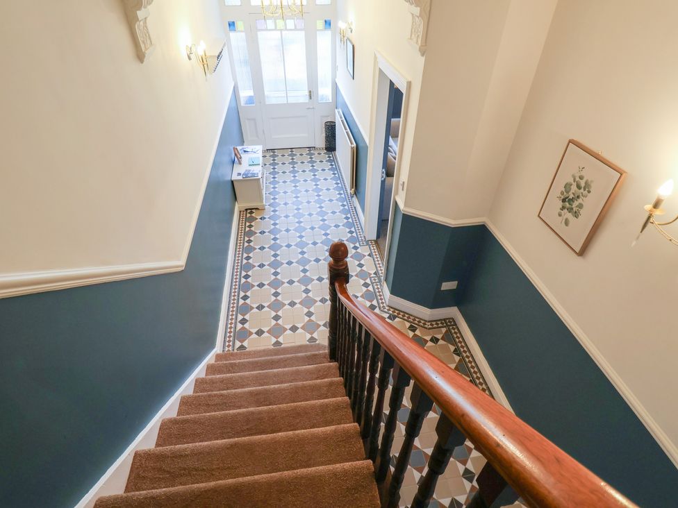 A hallway with stairs and a table at Kingfisher House in Staithes