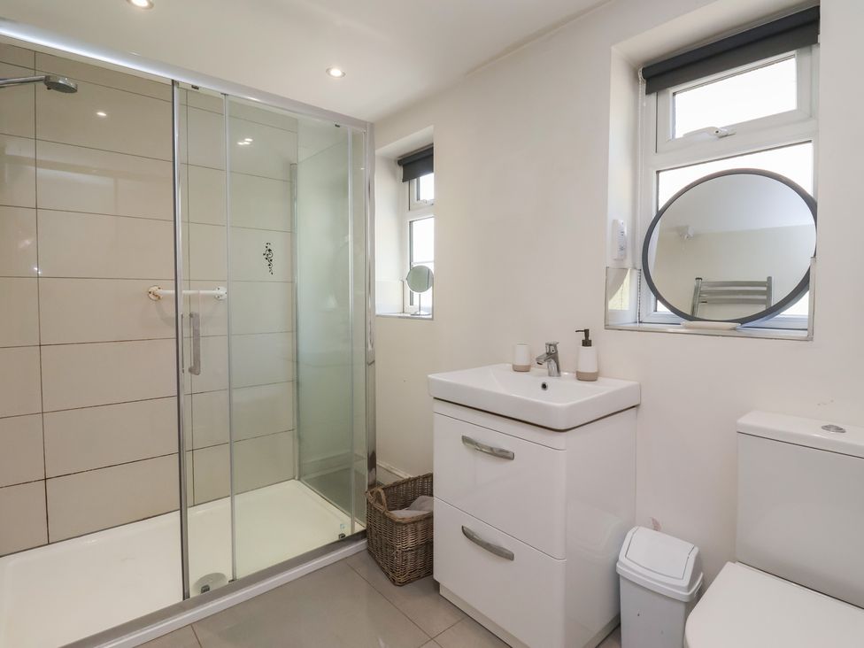 A bathroom with shower and sink at St Gregory’s Cottage Oswaldkirk near Helmsley