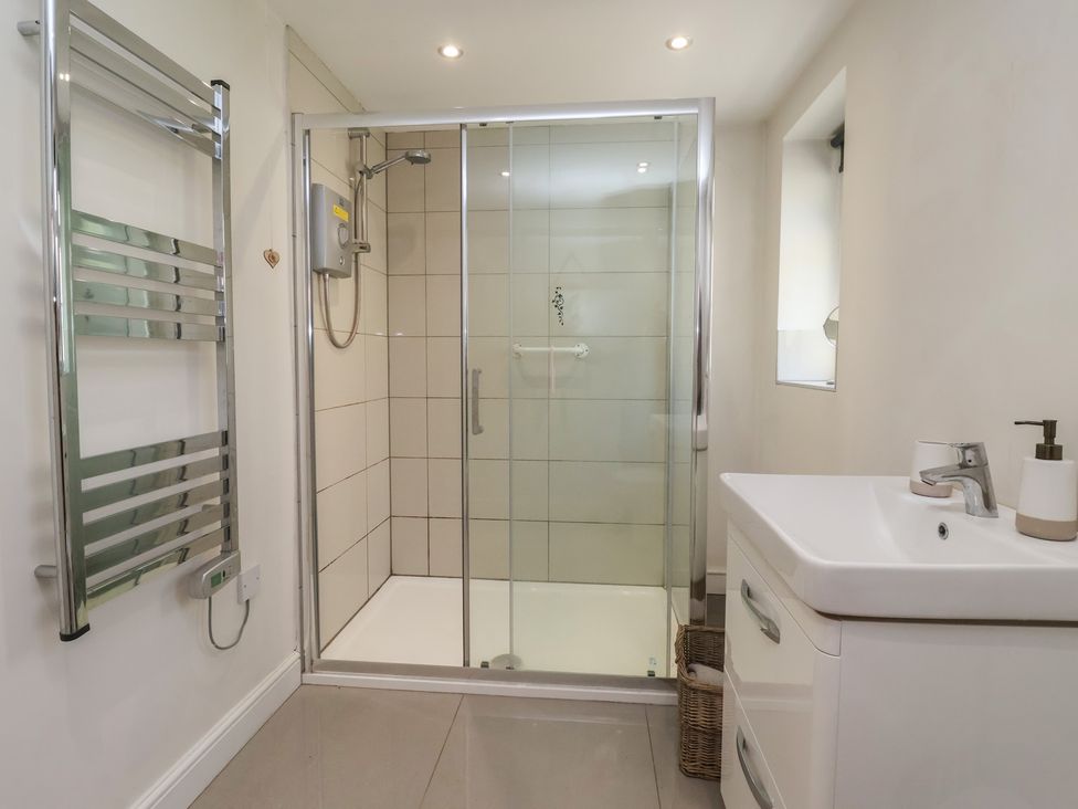 A bathroom with a shower and sink at St Gregory’s Cottage Oswaldkirk near Helmsley